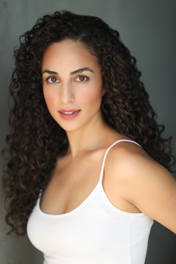 Parmiss Sehat professional headshot — curly dark hair, gray studio backdrop.